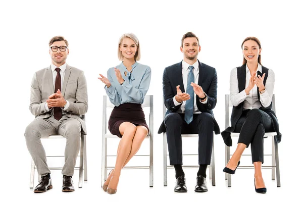 Businesspeople applauding and sitting on chairs isolated on white — Stock Photo