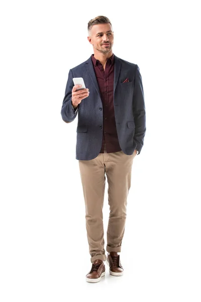 Handsome adult stylish man in jacket using smartphone isolated on white — Stock Photo