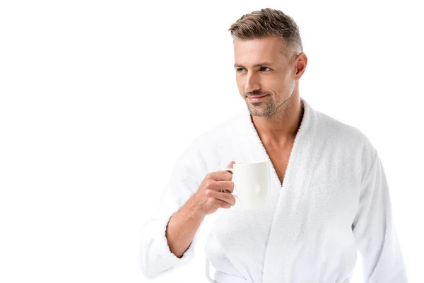 Homem alegre em roupão segurando xícara de café isolado no branco — Fotografia de Stock