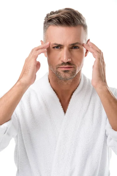 Upset man in bathrobe worrying about own appearance isolated on white — Stock Photo