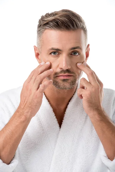 Man in bathrobe worrying about own appearance isolated on white — Stock Photo