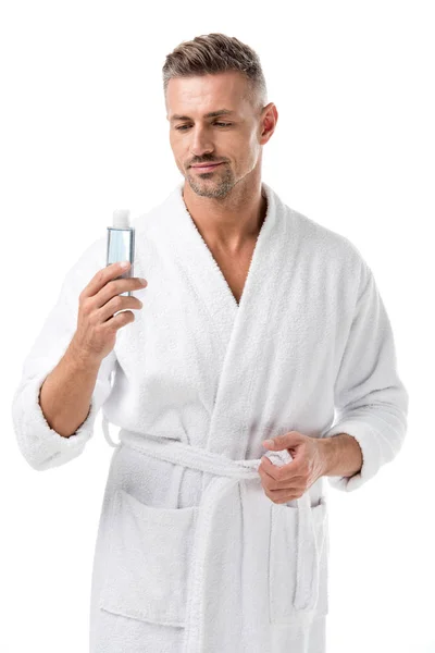 Hombre en albornoz celebración loción de afeitar aislado en blanco - foto de stock