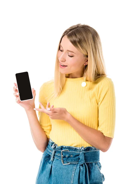 Улыбающаяся молодая женщина показывает смартфон с чистым экраном изолированы на белом — стоковое фото