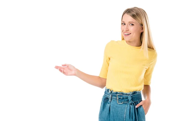 Happy young woman showing copy space and smiling at camera isolated on white — Stock Photo