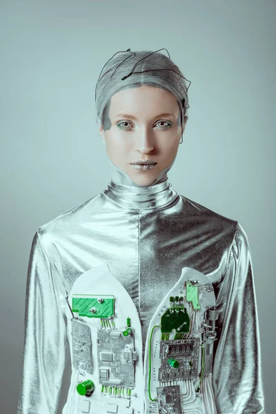 Futuristic silver female cyborg looking at camera isolated on grey, future technology concept — Stock Photo