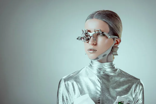 Futuristic silver robot looking away isolated on grey, future technology concept — Stock Photo