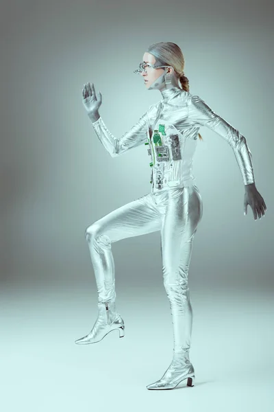 Side view of futuristic cyborg walking on grey, future technology concept — Stock Photo