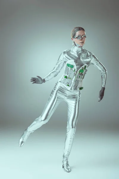 Full length view of silver woman robot balancing on grey, future technology concept — Stock Photo