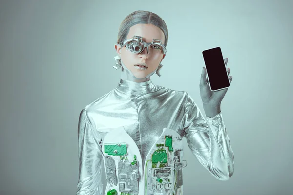 Robô segurando smartphone com tela em branco e olhando para a câmera isolada no conceito de tecnologia cinza, futuro — Fotografia de Stock