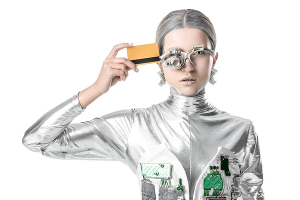 Silver robot touching head with credit card isolated on white, future technology concept — стоковое фото