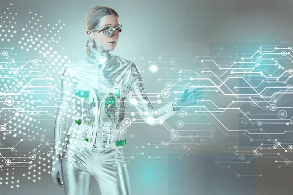 Silver robotic woman touching digital data with hand on grey, future technology concept — Stock Photo