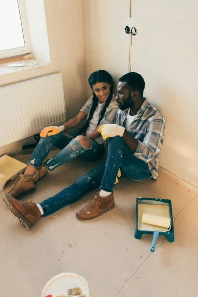 High angle view of young couple relaxing on floor during renovation of home — Stock Photo