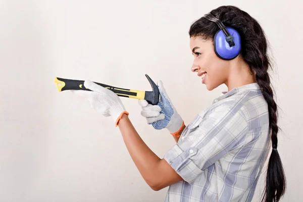 Jovem brincalhão se divertindo com o martelo durante a renovação da casa — Fotografia de Stock