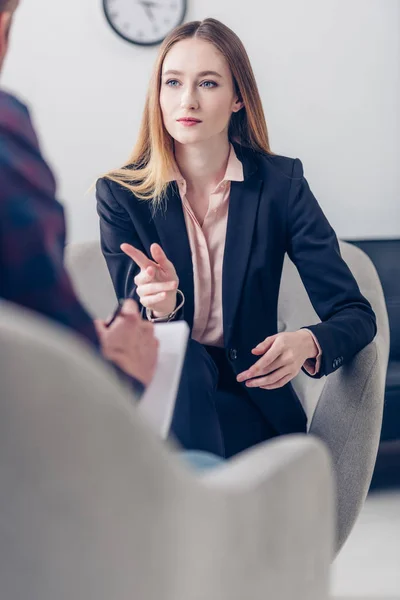 Focalizzazione selettiva della donna d'affari in giacca e cravatta che rilascia intervista al giornalista e lo indica in carica — Foto stock