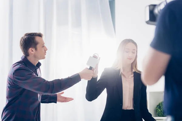 Low angle view of beautiful businesswoman in suit rejecting giving interview to journalist in office — Stock Photo