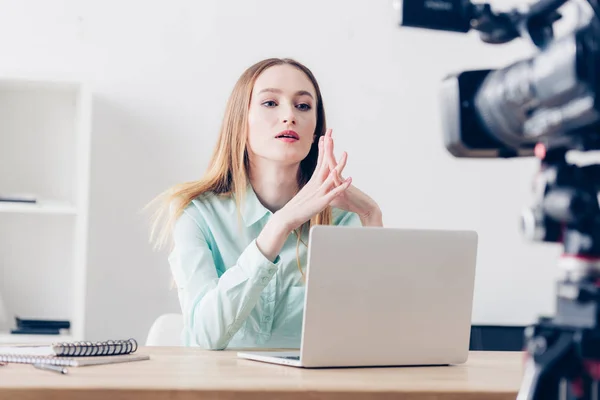 Serious attractive female video blogger recording vlog in office — Stock Photo