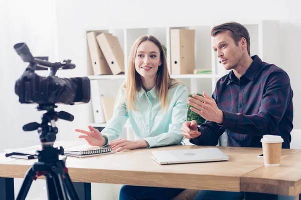 Smiling colleagues recording vlog in office — Stock Photo