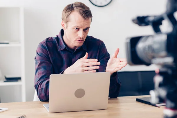 Serious handsome male video blogger recording vlog in office — Stock Photo