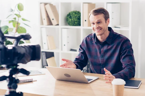 Happy handsome male video blogger recording vlog in office — Stock Photo