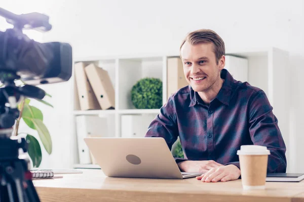 Smiling handsome male video blogger recording vlog in office — Stock Photo