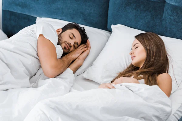 Atractiva pareja joven durmiendo juntos en la mañana - foto de stock