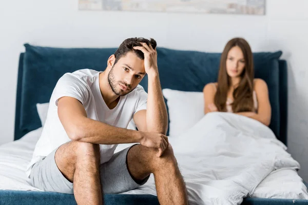 Selective focus of sad man with sexual problems sitting in bed — Stock Photo