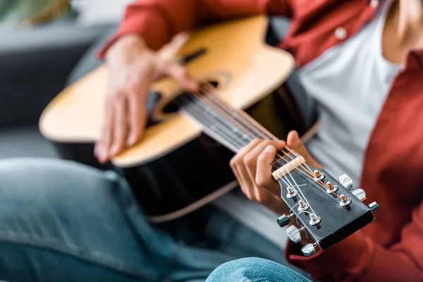 Partial view of adult man playing guitar — Stock Photo