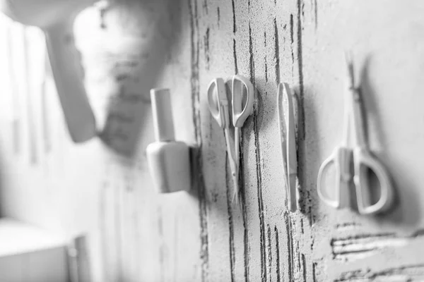 White decorative manicure tools on wall in beauty salon — Stock Photo