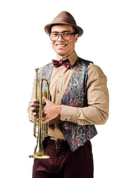 Laughing young mixed race male jazzman posing with trumpet and looking at camera isolated on white — Stock Photo