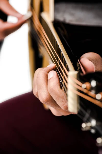 Cropped image of male musician playing on acoustic guitar isolated on white — Stock Photo