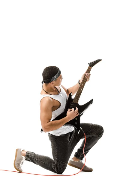 Young mixed race rocker playing on electric guitar isolated on white — Stock Photo