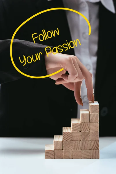 Cropped view of woman climbing with fingers wooden career ladder, 'follow your passion' lettering on foreground — Stock Photo