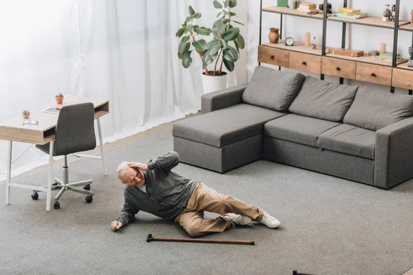 Old man falled down on floor of the room — Stock Photo