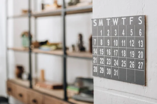 Selective focus of wall calendar showing dates at living room — Stock Photo