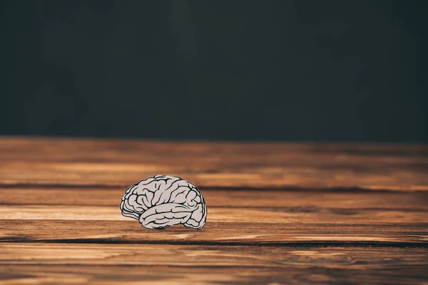 Paper with brain shape as alzheimer symbol on black background — Stock Photo