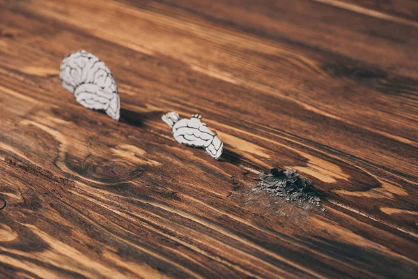 Papers with brain disease as dementia symbol on wooden table — Stock Photo