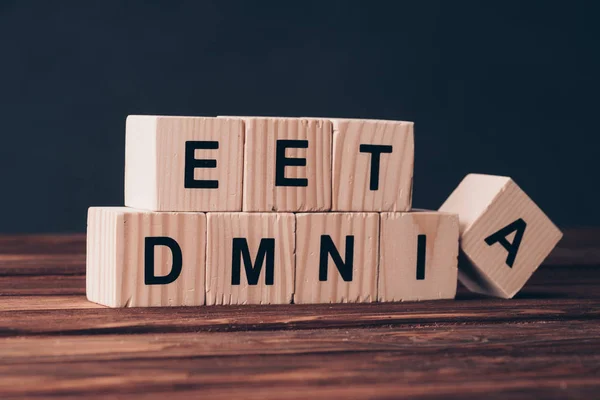 Wooden cubes with dementia word on black background — Stock Photo