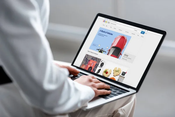 Cropped view of woman using laptop with ebay website on screen — Stock Photo