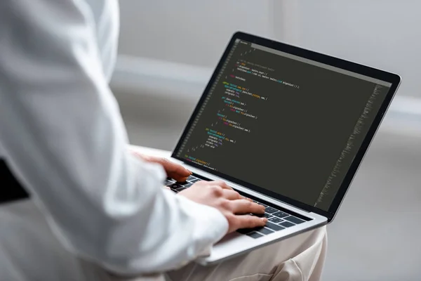 Cropped view of woman using laptop with microsoft windows on screen — Stock Photo