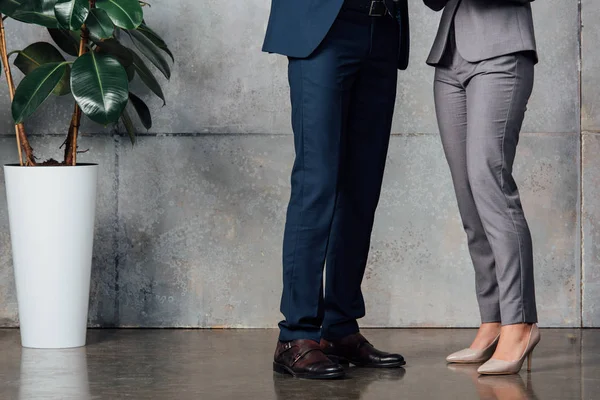 Cropped view of businesspeople in formal wear in office — Stock Photo