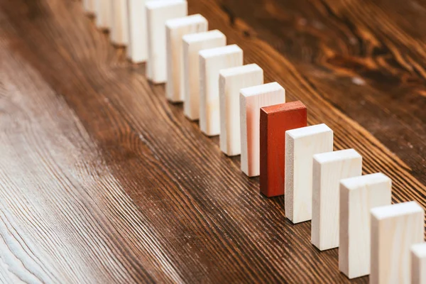 Row of wooden blocks with red one on desk with copy space — Stock Photo