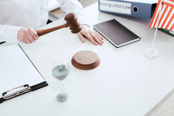 Cropped view of female judge with gavel in hand — Stock Photo