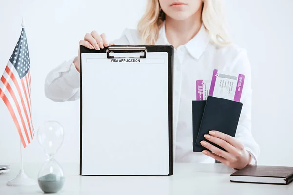 Cropped view of woman holding passports with tickets and clipboard with empty blank with visa application lettering — Stock Photo