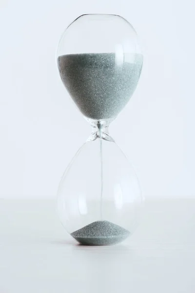 Transparent hourglass with running sand isolated on white — Stock Photo