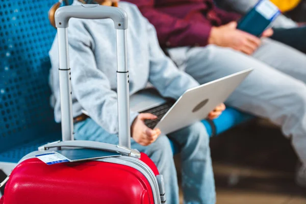 Foco selectivo de equipaje con el niño usando el ordenador portátil en el fondo — Stock Photo