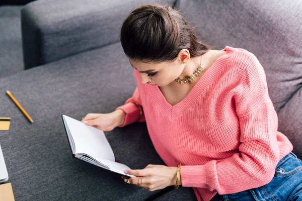 Attractive indian student reading book at home — Stock Photo