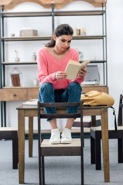 Indian student with bindi studying and reading book at home — Stock Photo