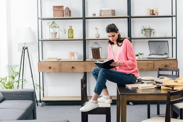 Female student with bindi studying with notebooks at home — Stock Photo