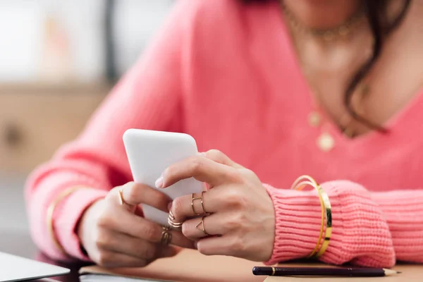 Cropped view of woman in pink clothes using smartphone — Stock Photo