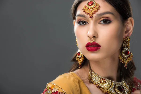Attractive indian woman posing in traditional bindi, isolated on grey — Stock Photo